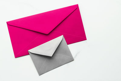 High angle view of red envelope against white background