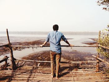 Rear view of man standing on beach