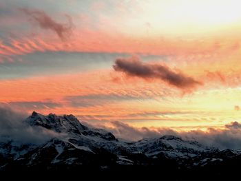 Scenic view of snowcapped mountains against sky during sunset