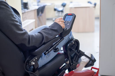 Midsection of man using mobile phone