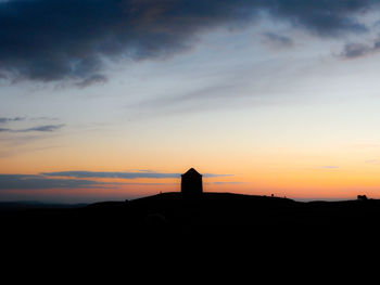 Silhouette temple against sky during sunset