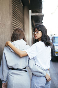 Friends walking together in city