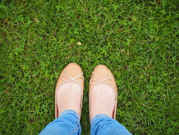 Low section of woman standing on grass