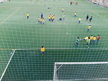 High angle view of people playing soccer on field