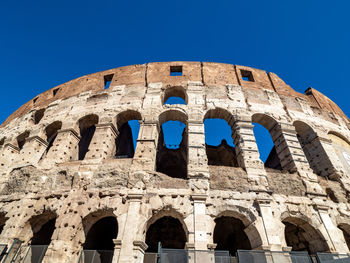 Low angle view of historical building against blue sky