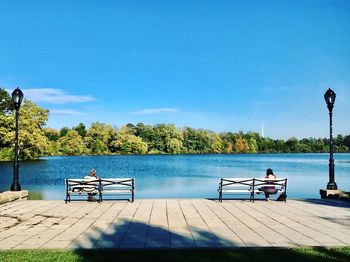 Scenic view of lake against clear blue sky