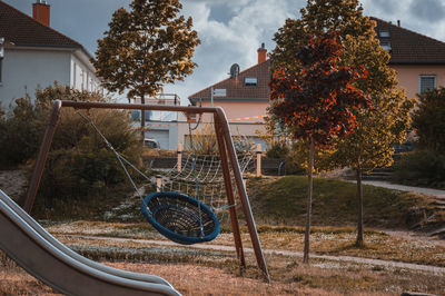 Bicycle by house against sky