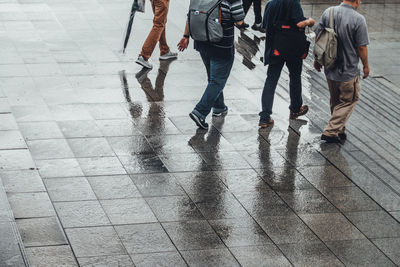 Low section of people walking on street