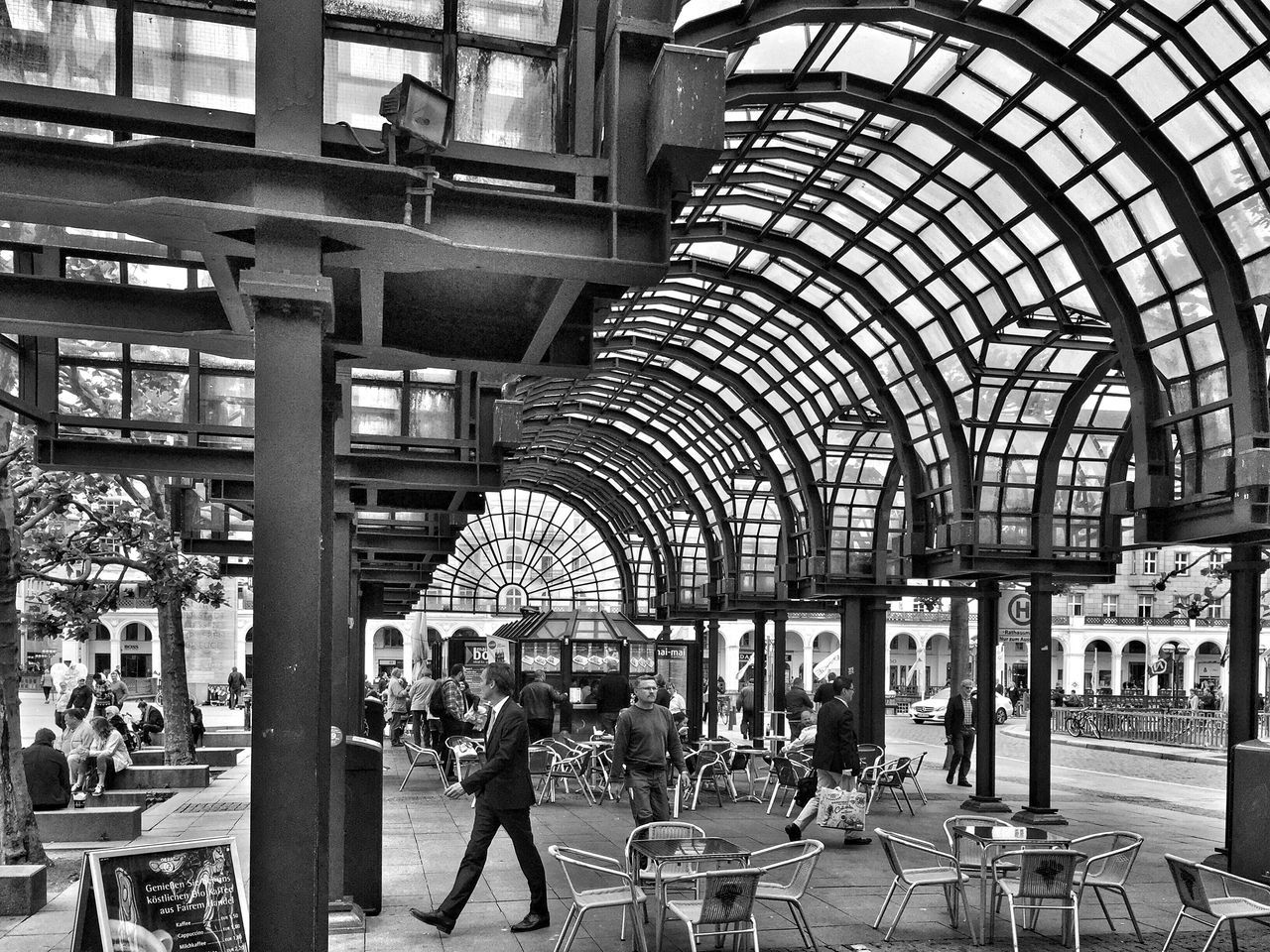 indoors, architecture, built structure, large group of people, ceiling, person, men, interior, travel, railroad station, arch, incidental people, architectural column, city life, lifestyles, public transportation, chair, travel destinations, retail