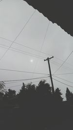 Low angle view of electricity pylon against sky