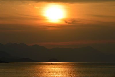 Scenic view of lake against sky during sunset