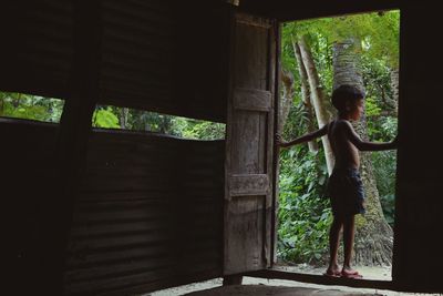 Girl standing by window