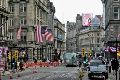 Cars on street against buildings in city