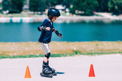 Boy rollerblading by lake