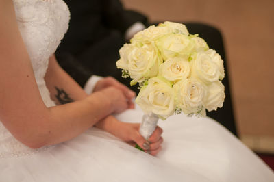 Midsection of woman holding flower bouquet