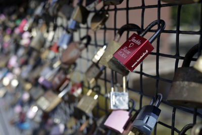 Close-up of padlocks hanging on fence