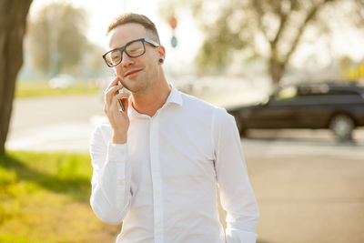 Young man using mobile phone outdoors