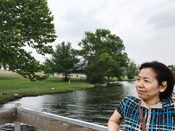 Man and woman in river against sky