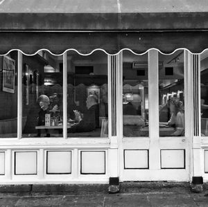 Reflection of people on glass window