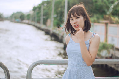 Young woman standing on bridge