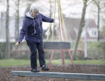 Full length of man on bench in park