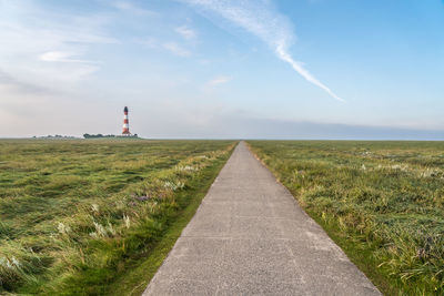 Lighthouse by sea against sky