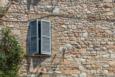 Windows in the facades of ancient medieval houses