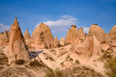 Rock formations in desert against blue sky