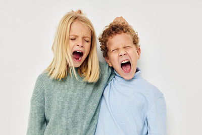 Sibling fighting against white background