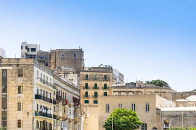 Buildings against blue sky in city