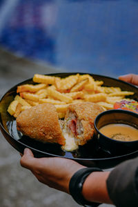 Cropped hand of person holding food