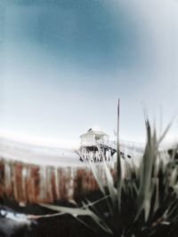 Close-up of snow covered land against sky