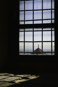 Silhouette building seen through window