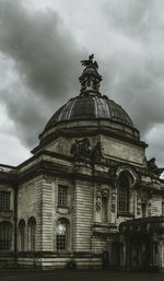 Low angle view of building against cloudy sky