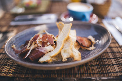 Close-up of breads and meat in plate