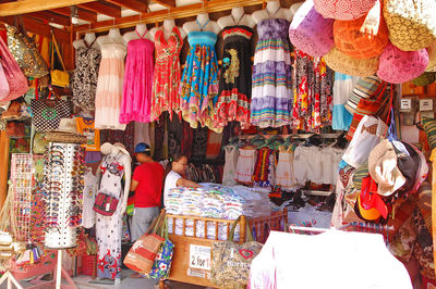 Multi colored flags hanging in store for sale at market stall