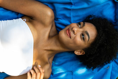 Portrait of smiling young woman lying down