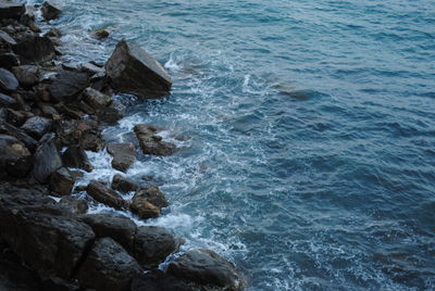 High angle view of rocks in sea