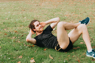 Young man lying on field