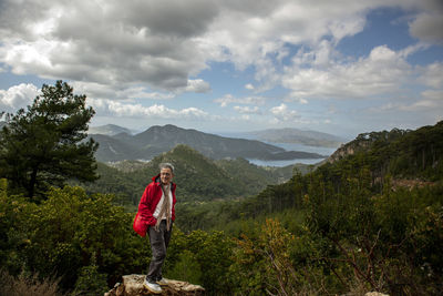 Man standing on mountain against sky