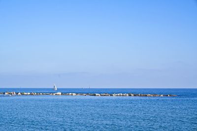 Scenic view of sea against blue sky