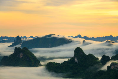 Scenic view of mountains against orange sky