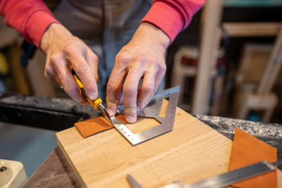 Midsection of man working at workshop