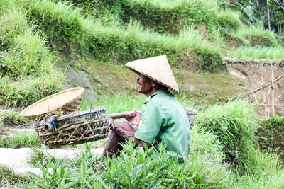 Side view of senior man sitting in field