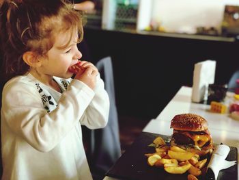 Midsection of girl looking at table