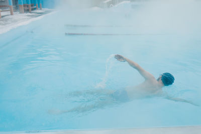 High angle view of woman swimming in pool