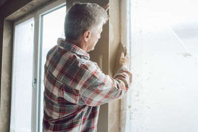 Side view of man working at home