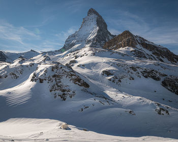 Scenic view of snowcapped mountains against sky