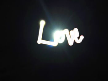 Illuminated lamp post at night