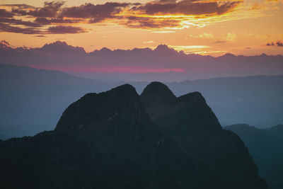 Scenic view of silhouette mountains against sky during sunset